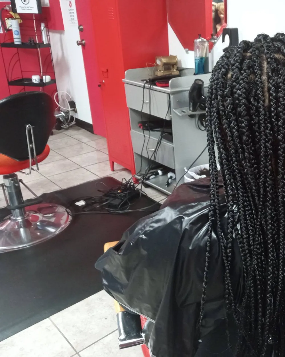 Box braids styled at Queenreal's Beauty Stop, side profile
