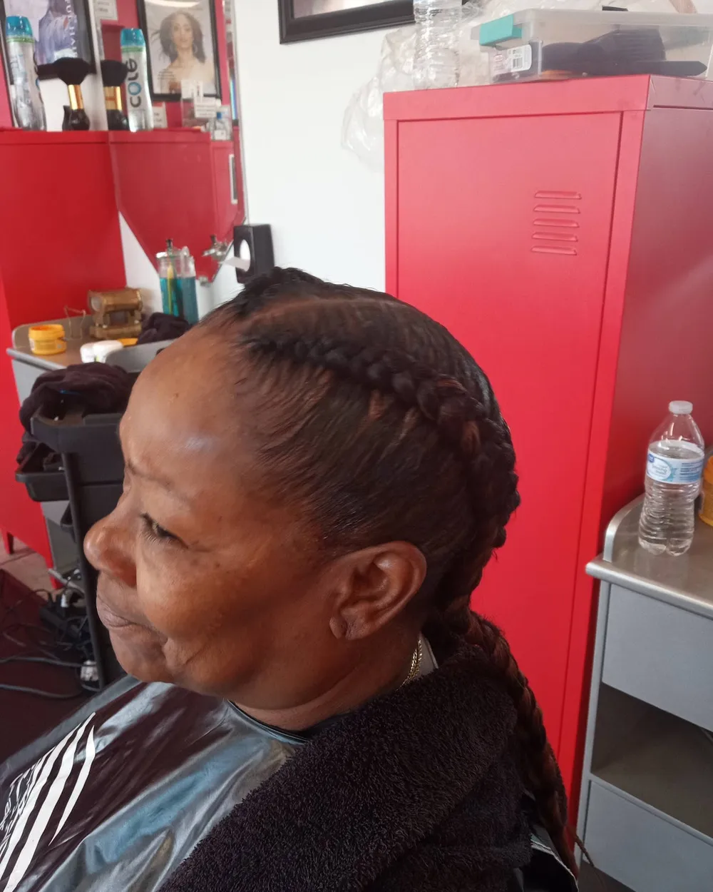 Cornrow braids styled at Queenreal's Beauty Stop