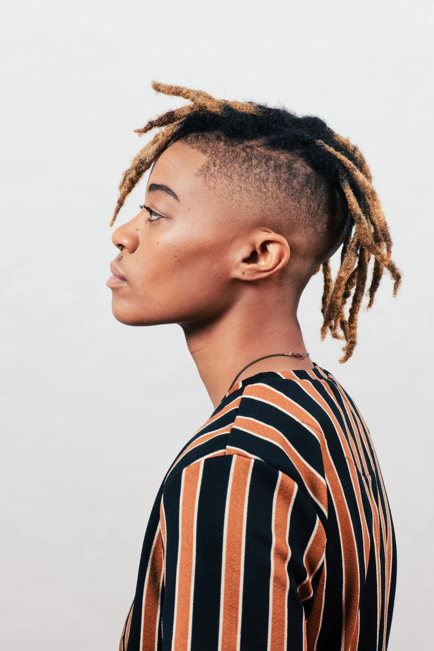 Faux locs styled in side profile